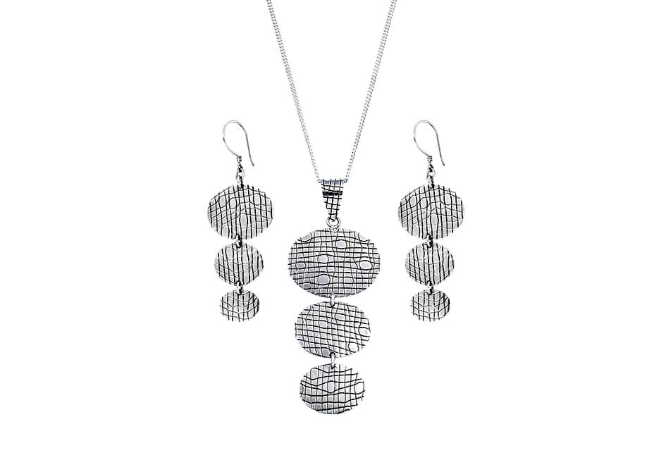 3-tier pendant necklace and earrings set from Hill to Street over a white background