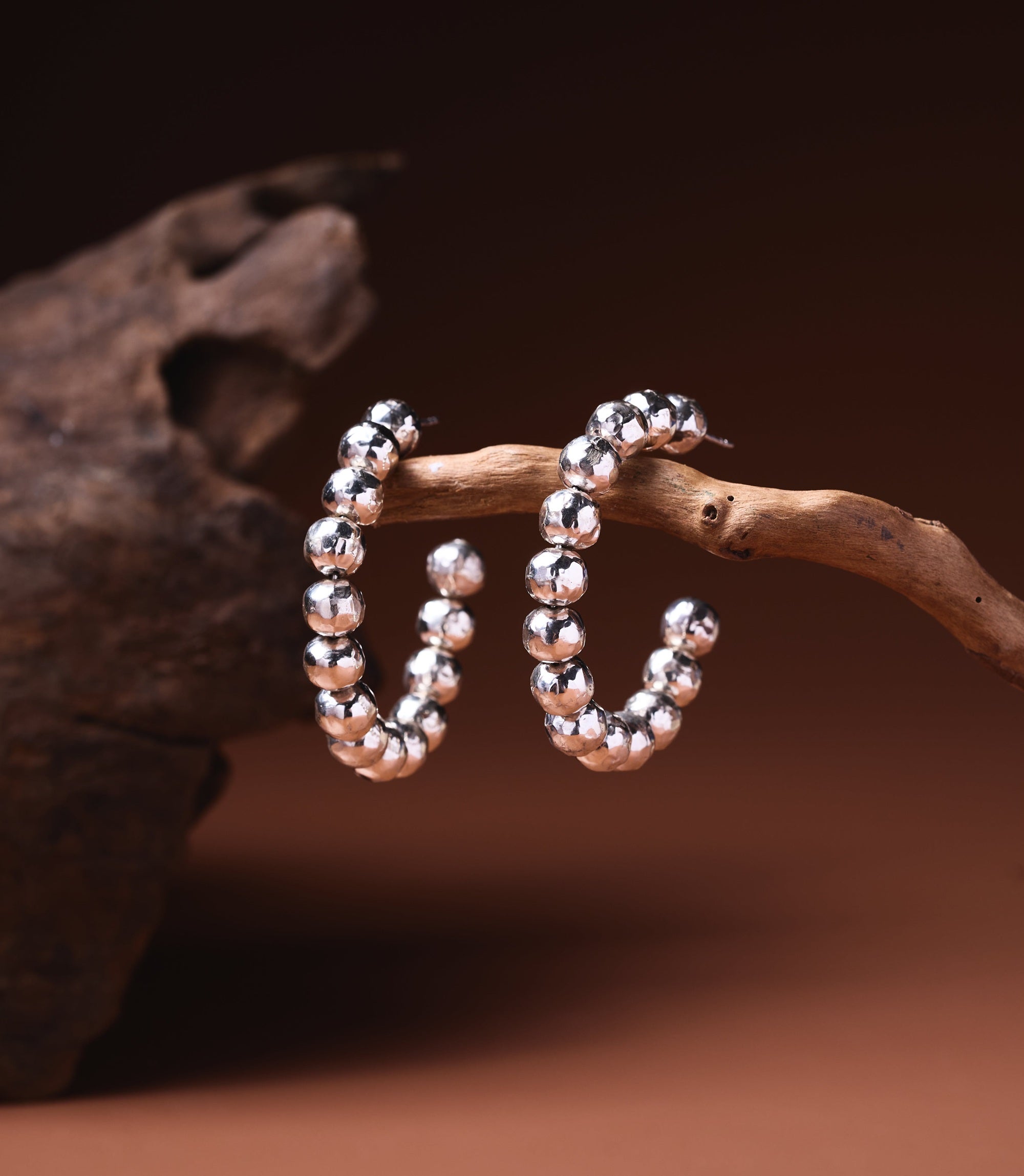 Anna Hoop Earrings in 925 sterling silver showing a row of hand-hammered silver balls forming the hoop.