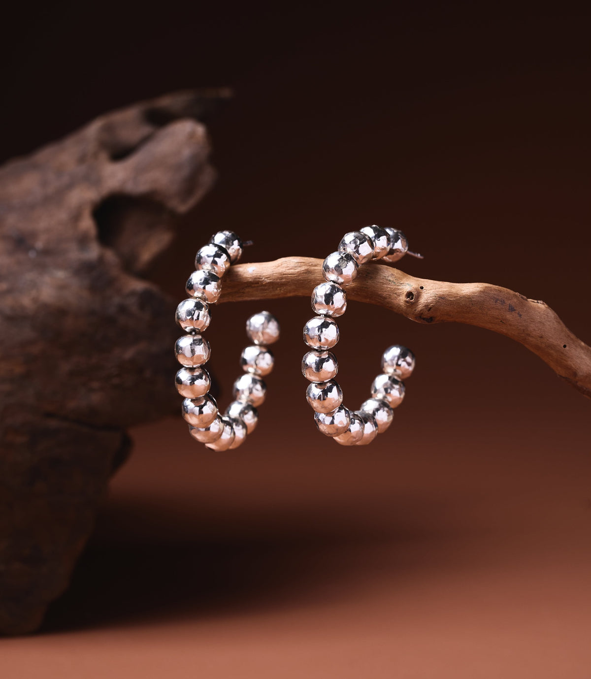 Anna Hoop Earrings in 925 sterling silver showing a row of hand-hammered silver balls forming the hoop.