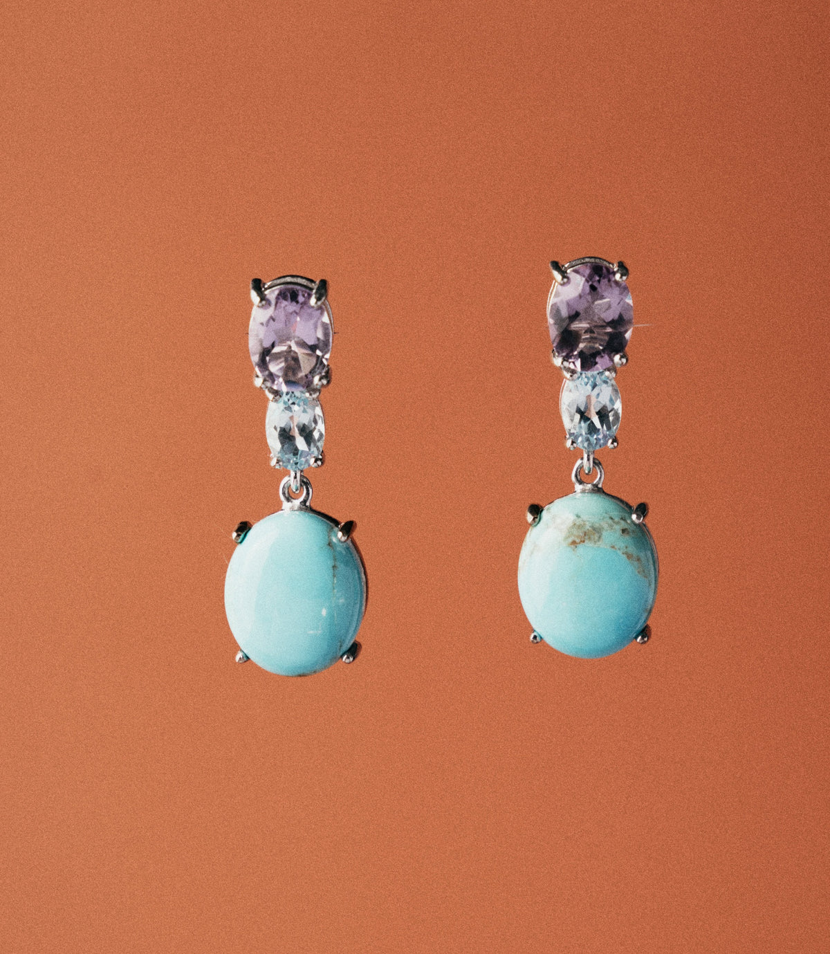 Handcrafted sterling silver 925 drop earrings with synthetic turquoise cabochon and oval amethyst stones. A vibrant, artisan everyday earring.