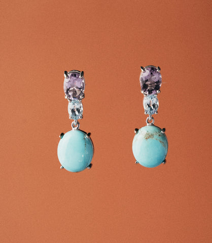 Handcrafted sterling silver 925 drop earrings with synthetic turquoise cabochon and oval amethyst stones. A vibrant, artisan everyday earring.