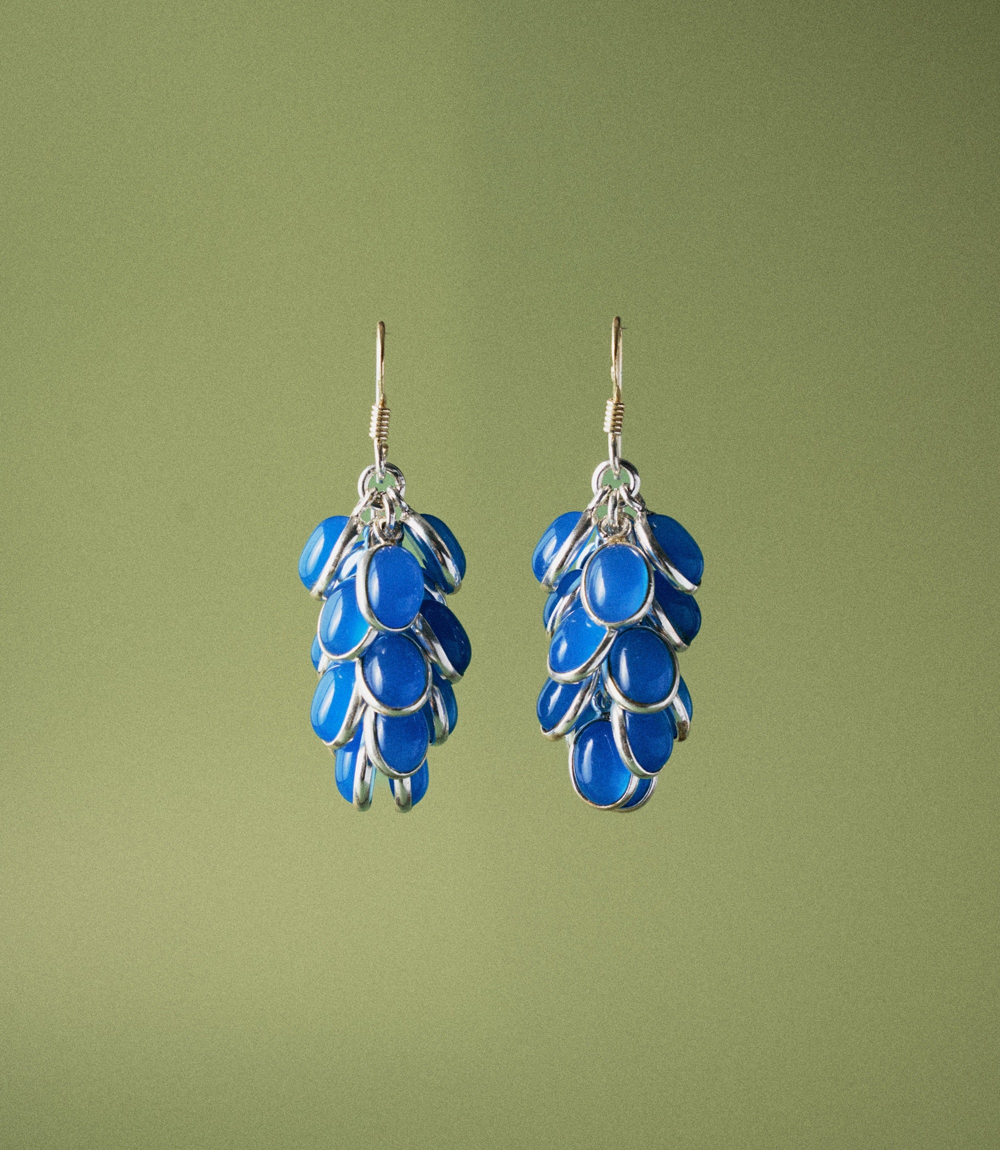 Vivia Earrings in 925 sterling silver featuring blue chalcedony oval cabochons arranged in a cascading grape-cluster drop design