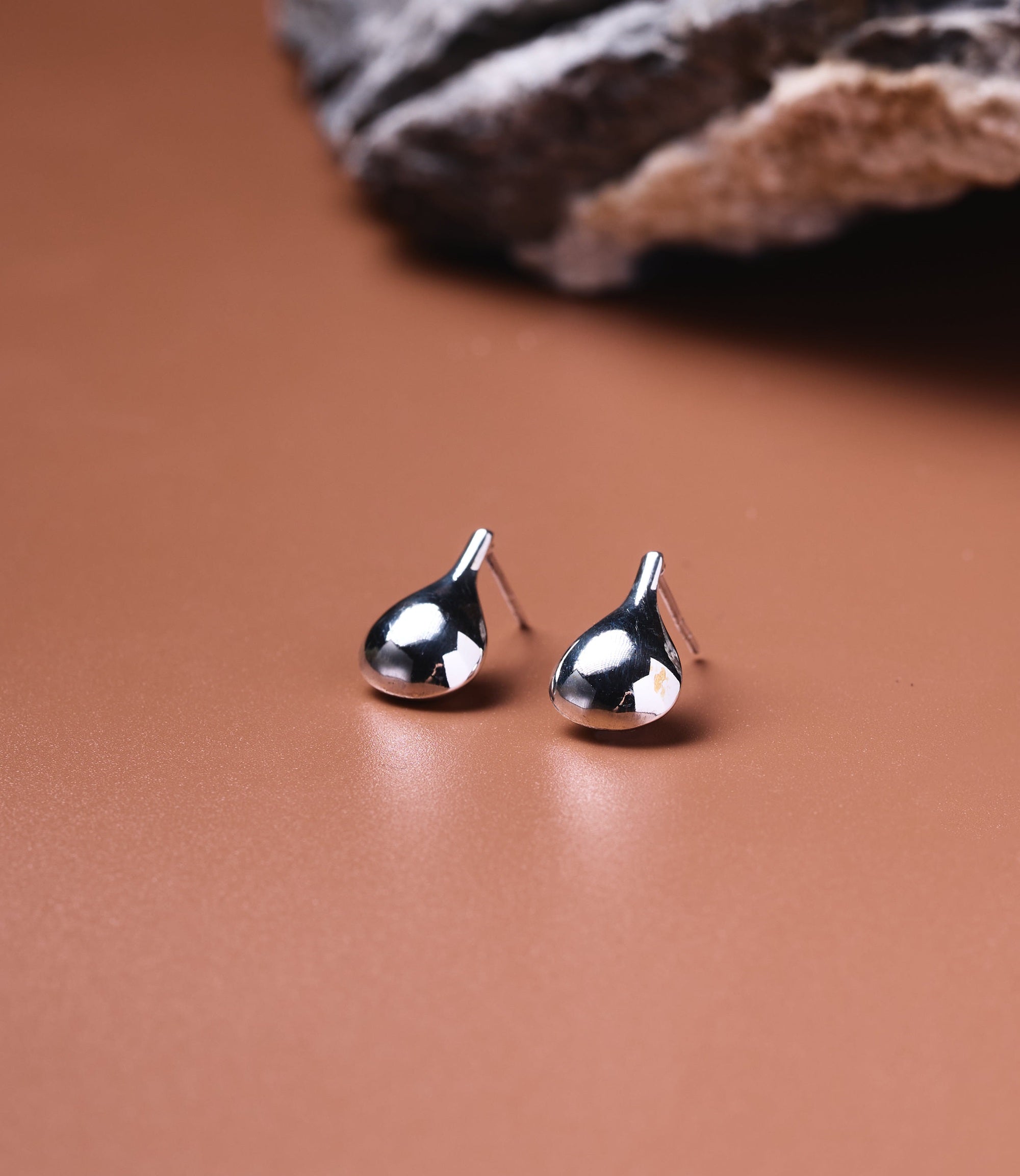 Wren Sterling Silver Water Drop Earrings, polished 925 teardrop stud earrings on a neutral surface