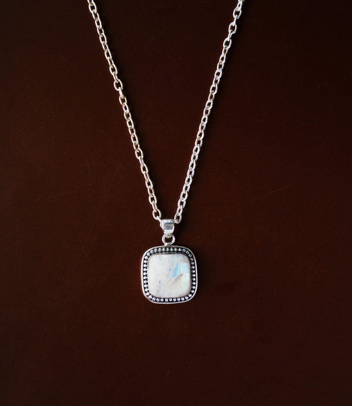 The Aveline Necklace in 925 sterling silver featuring a luminous moonstone pendant with a soft natural glow.