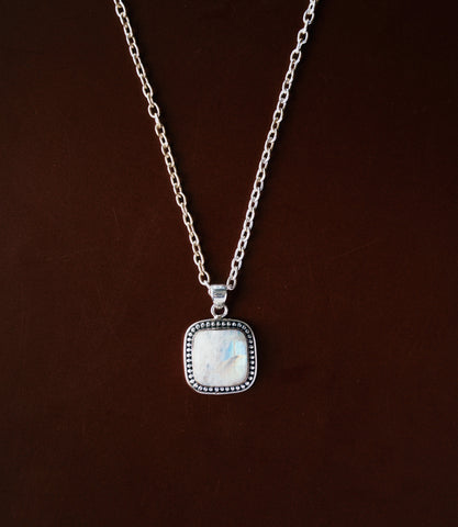 The Aveline Necklace in 925 sterling silver featuring a luminous moonstone pendant with a soft natural glow.