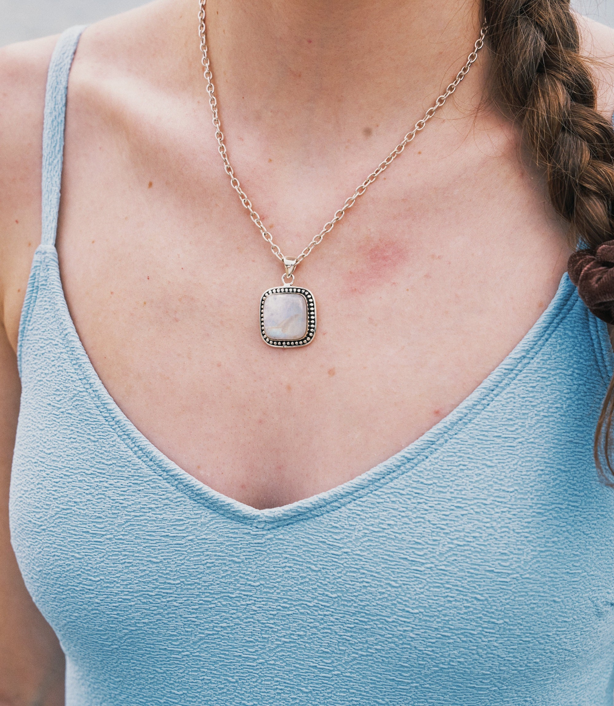 Model wearing the Aveline Necklace, a minimalist 925 sterling silver necklace with a moonstone pendant.