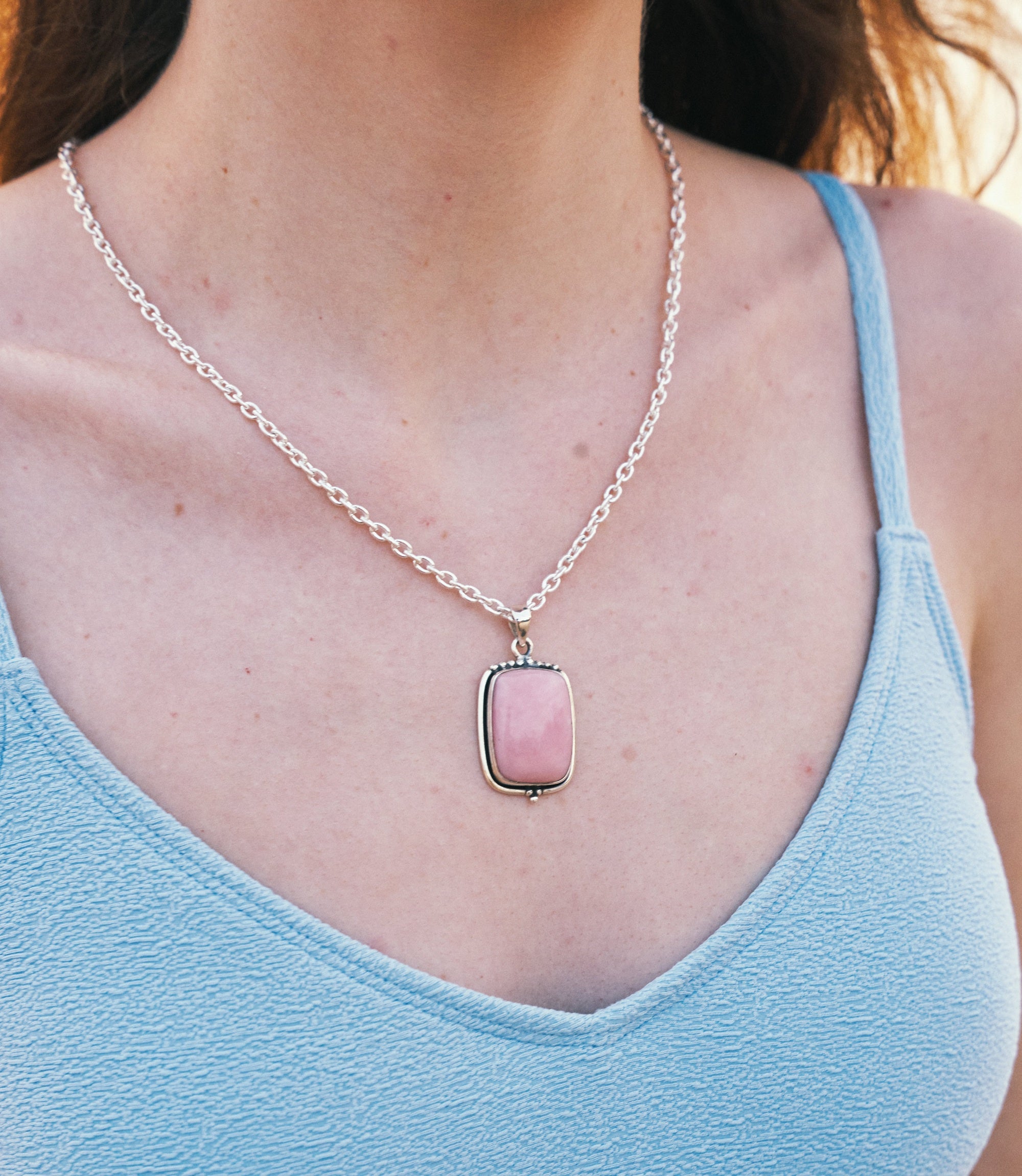 Model wearing the Elodie Necklace, a minimalist 925 sterling silver necklace with a delicate pink opal pendant.
