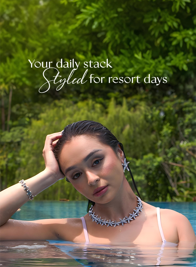 Model in a pool wearing a silver starfish necklace and bracelet: your daily stack, styled for resort days