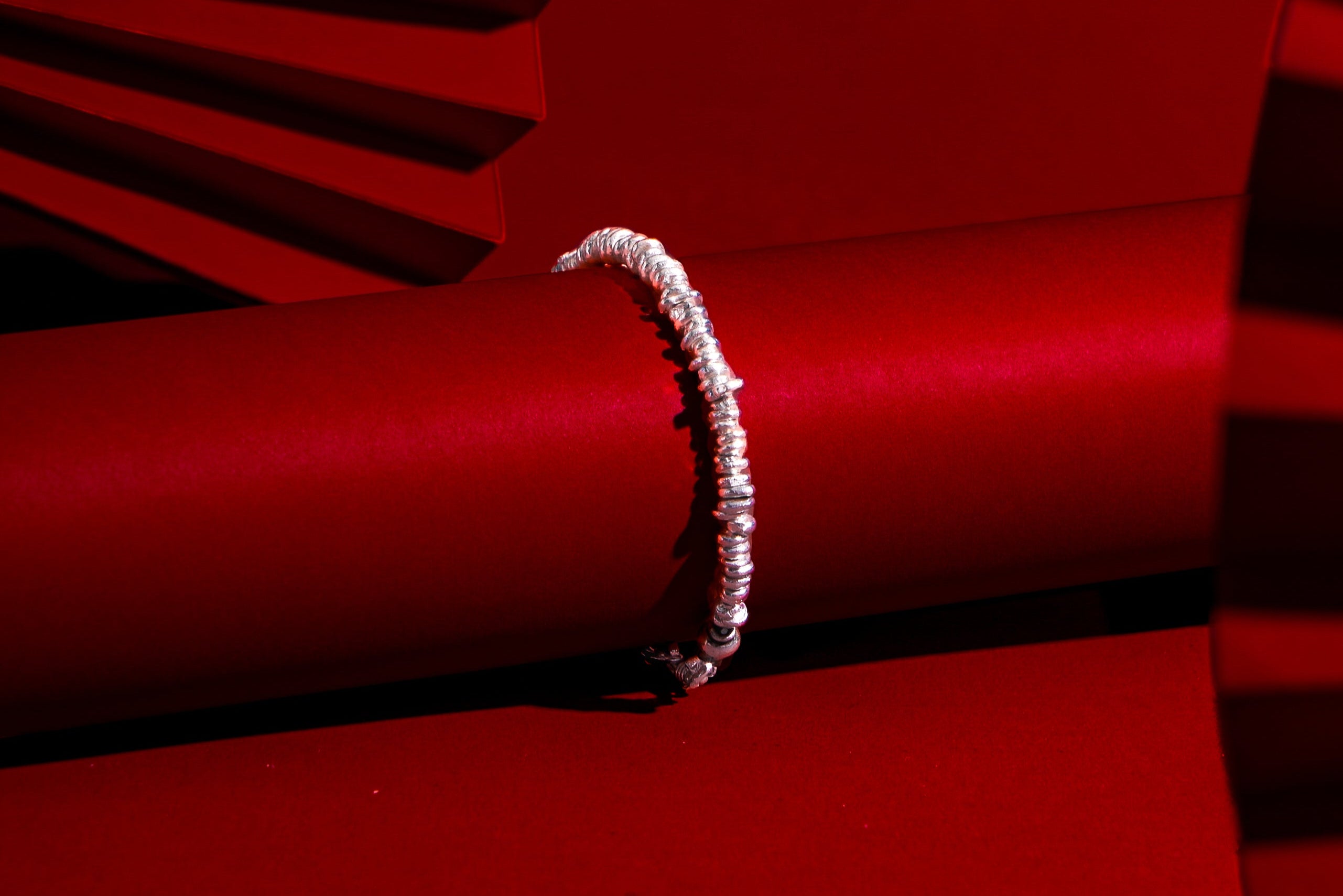 Close-up of the Cora Bracelet showcasing its organically shaped pure silver beads and handcrafted finish.