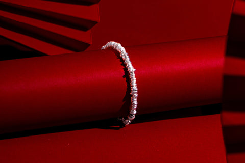 Close-up of the Cora Bracelet showcasing its organically shaped pure silver beads and handcrafted finish.