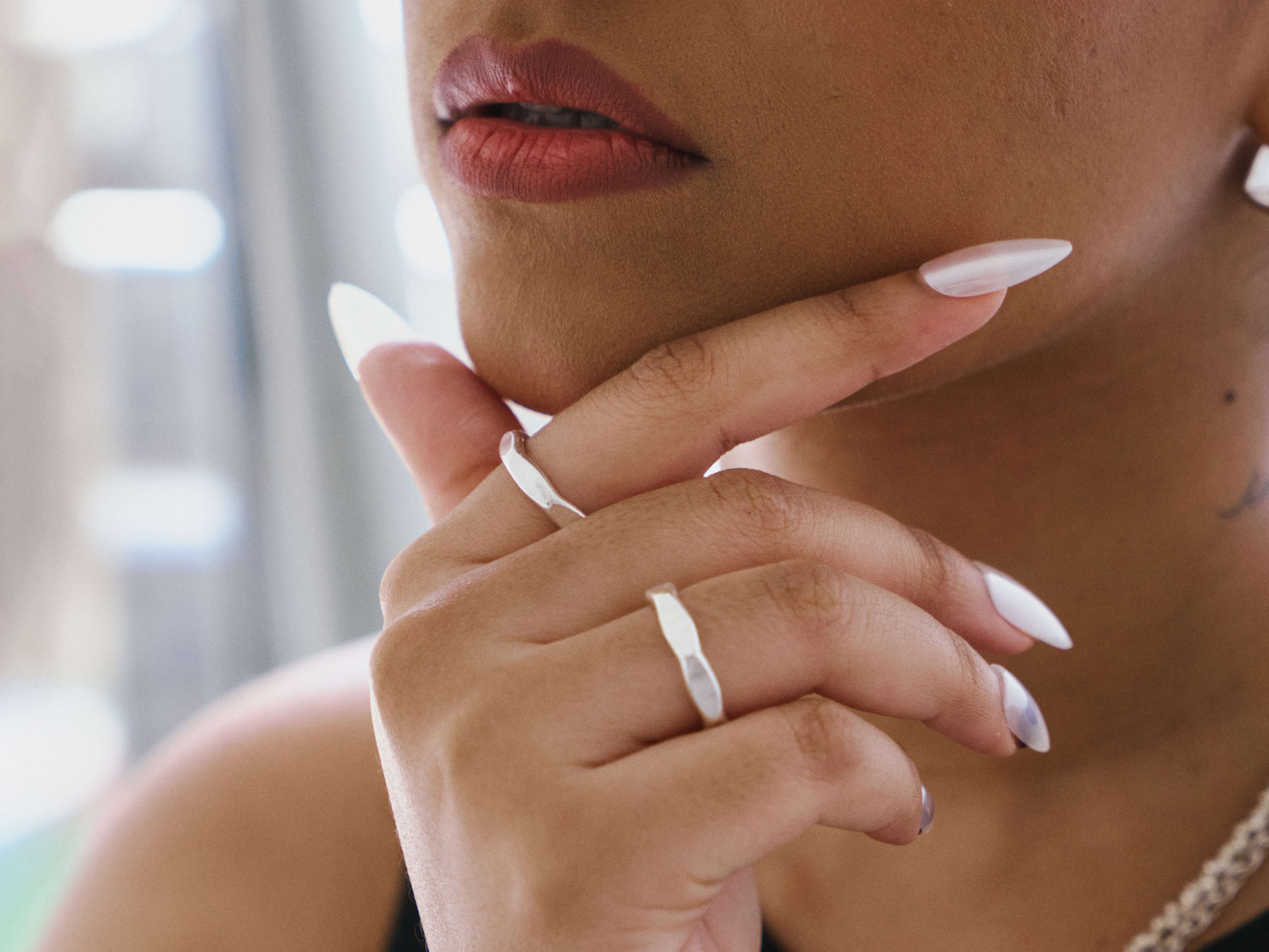 Model wearing Venn Ring, a minimalist pure silver stacking ring for everyday styling.