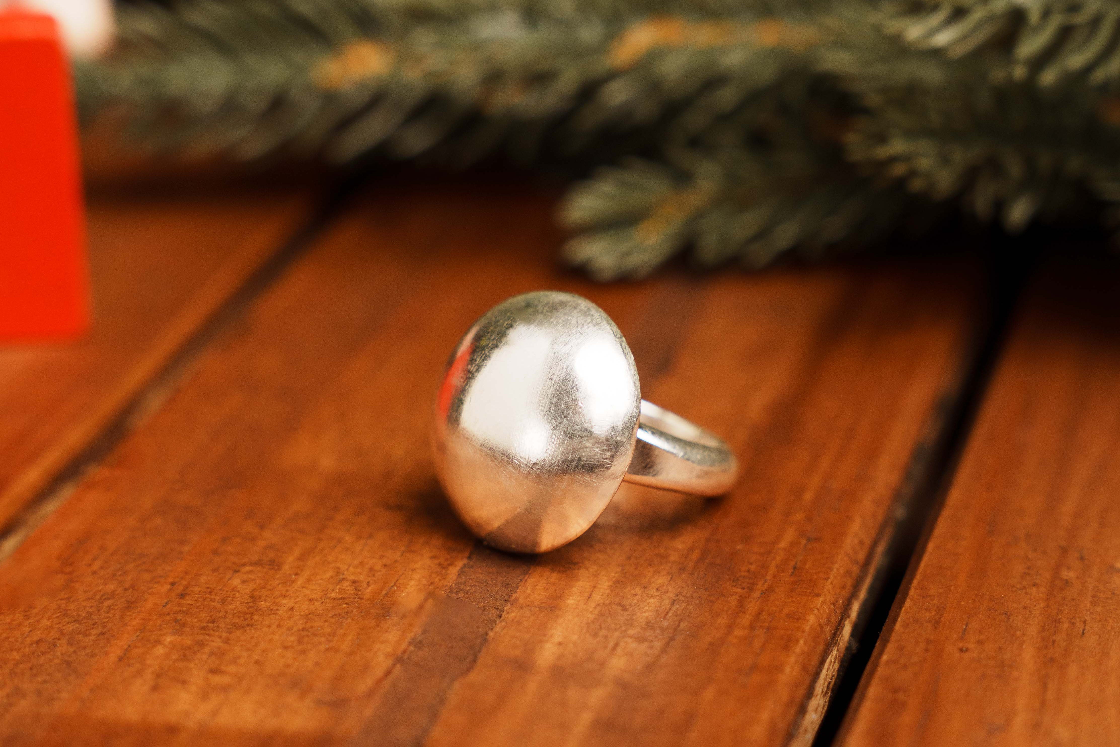Close-up of the Orla Ring showing the curved domed surface and polished pure silver finish.
