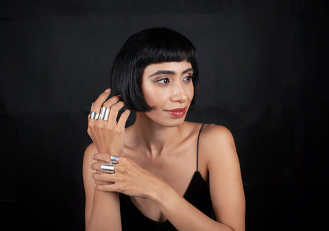 Model wearing Alia hammered silver ring from Hill to Street over black background