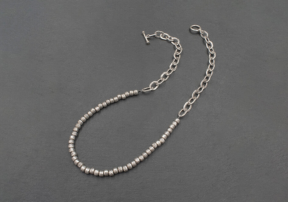 Dual beads chain necklace from Hill to Street over grey background