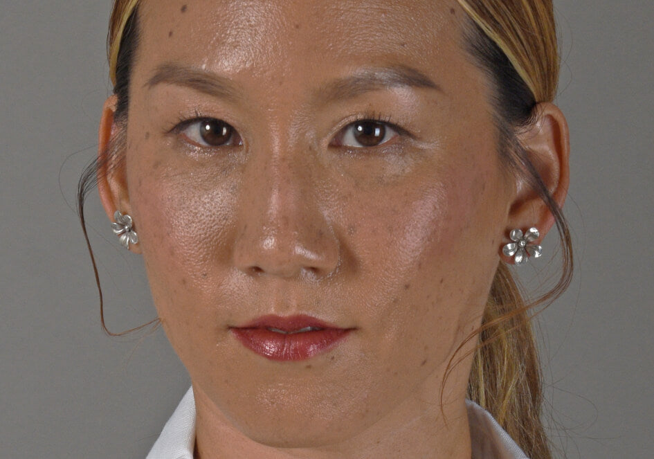 Model wearing a pair of fleur silver stud earrings from Hill to Street