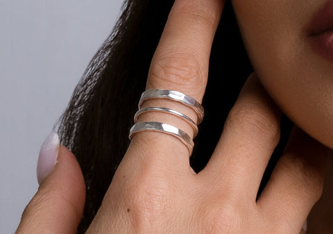 Close-up of The Ashley Ring showcasing its handcrafted hammered texture and wide pure silver band.