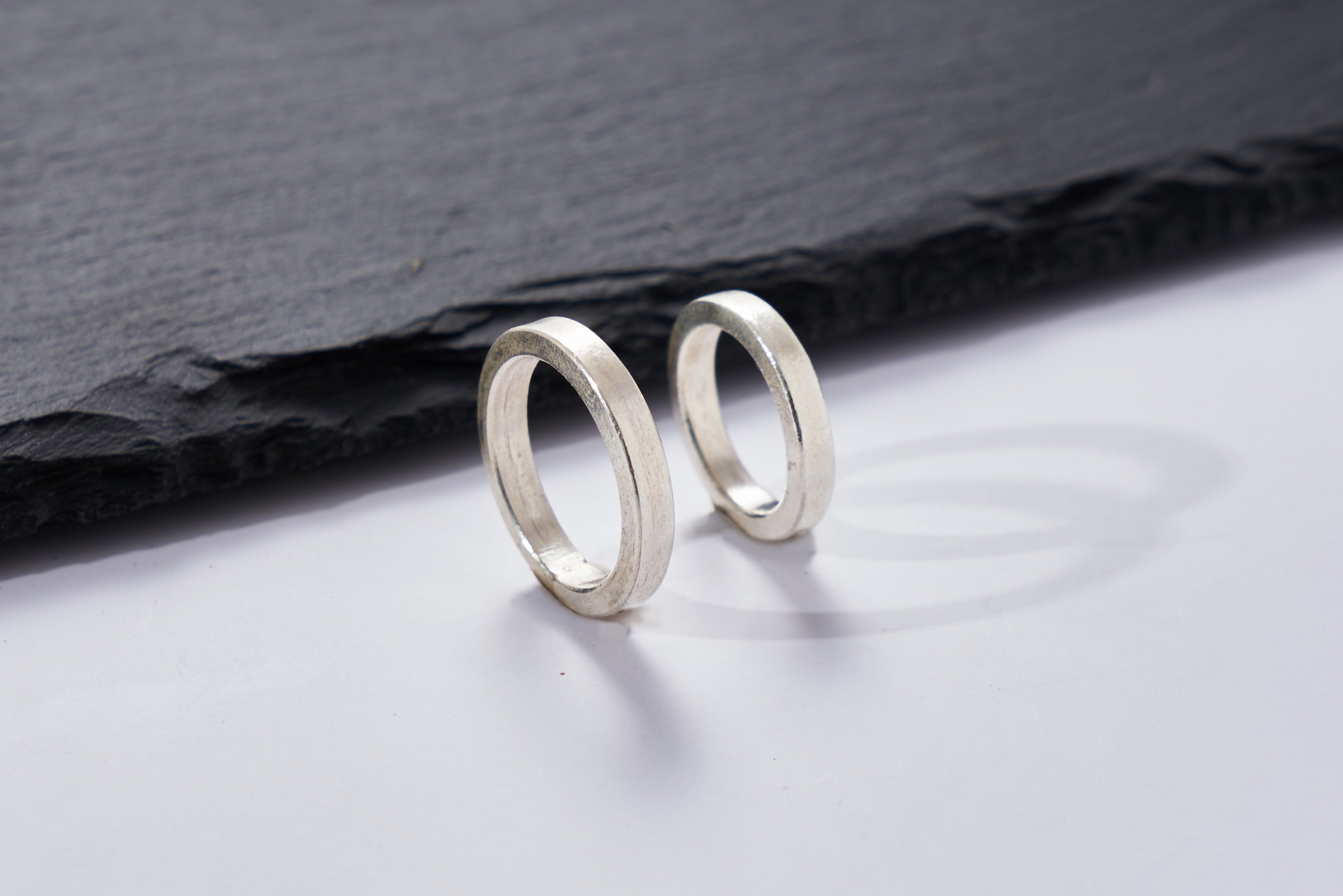 Close-up of the Aiden Band Ring showing its high-polish pure silver finish and seamless band edge