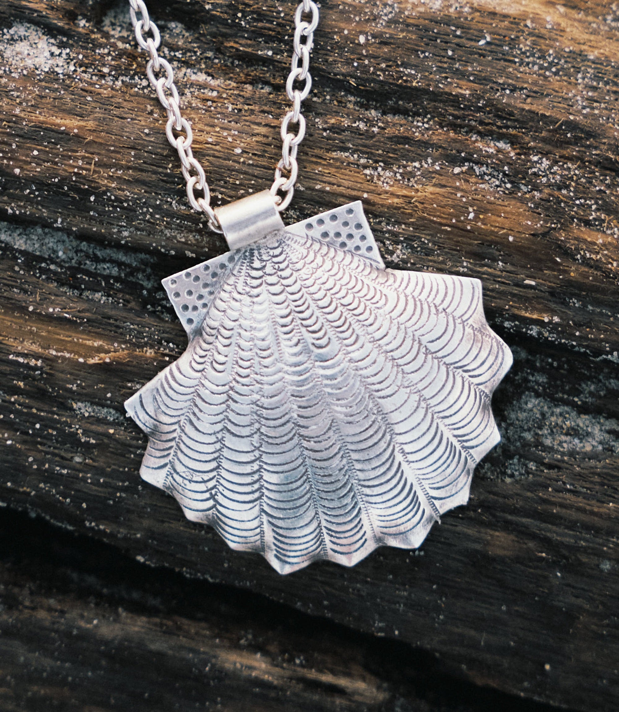 Close-up of the Amelia Necklace showing fine silverwork and shell motif detailing on a pure silver pendant