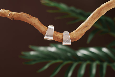 Pure silver trapezoid stud earrings handcrafted by Hill To Street, photographed on a neutral background