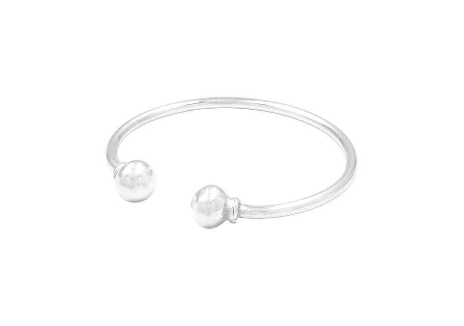 Close-up of Jordy Bangle showing smooth pure silver ball ends on an open-cuff bangle