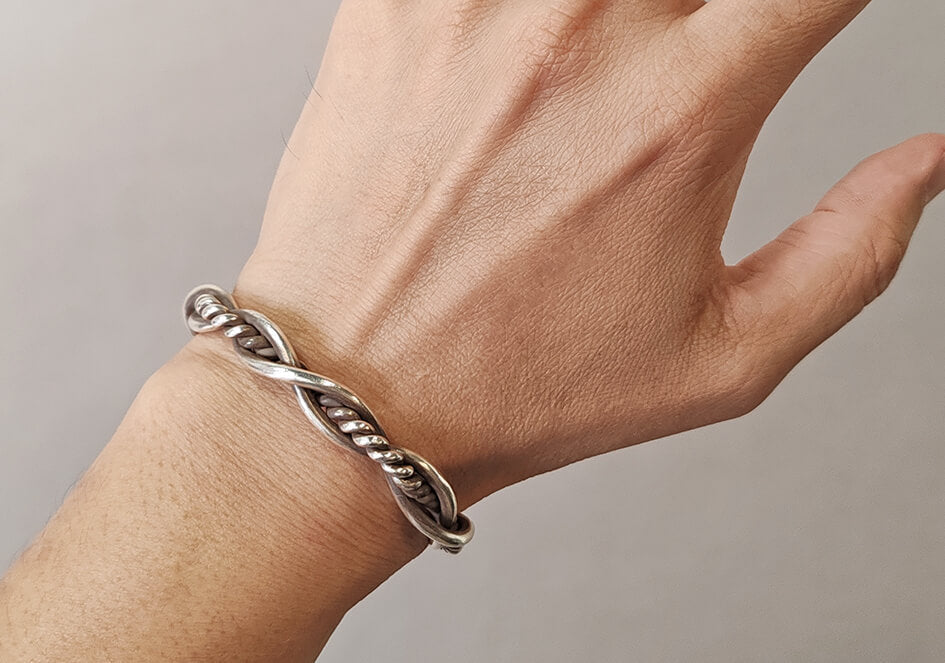 Rowan Bangle worn on wrist alongside a watch, styled for everyday masculine wear
