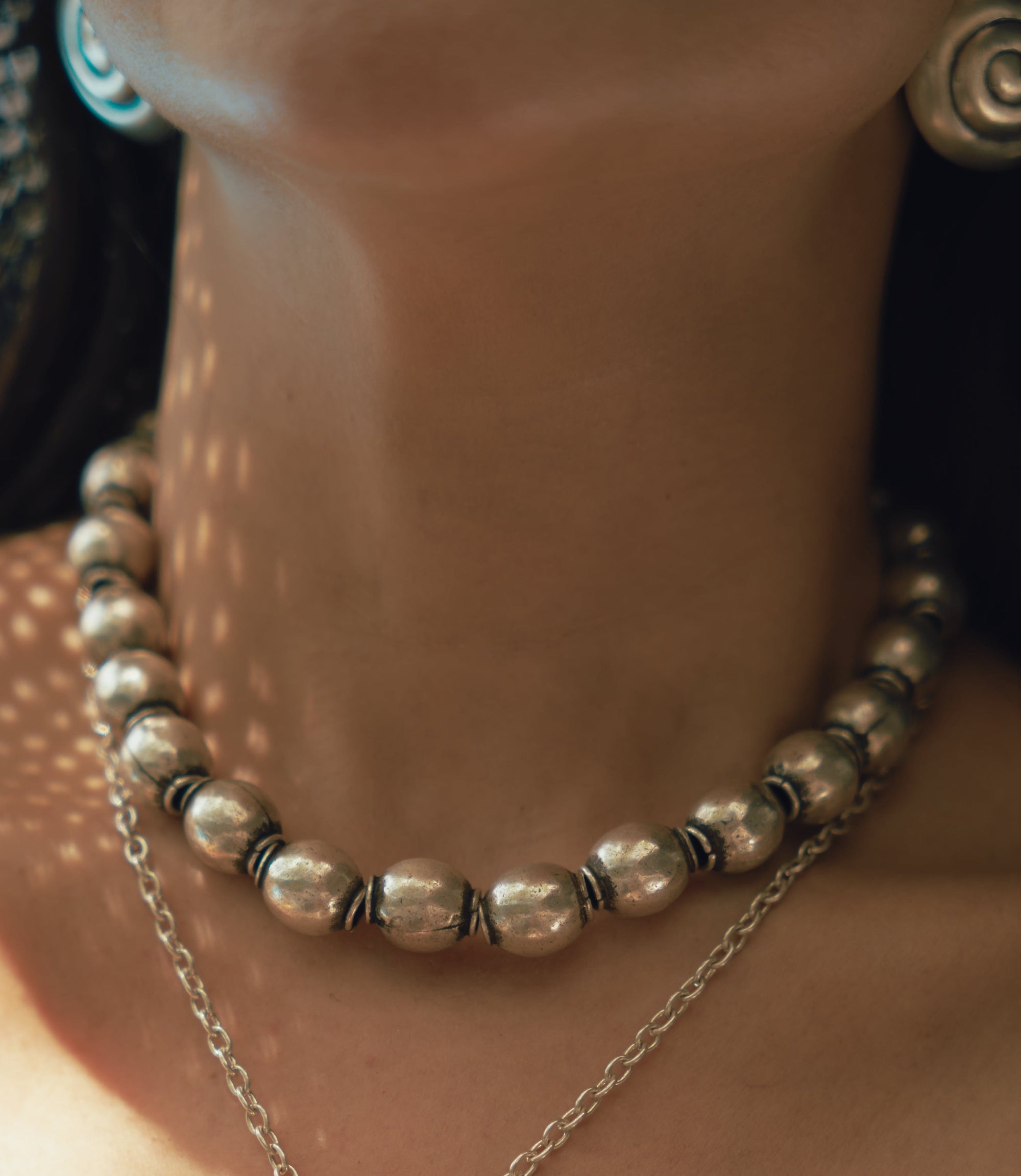 Model wearing Zuma necklace showcasing its bold weight and street-inspired presence