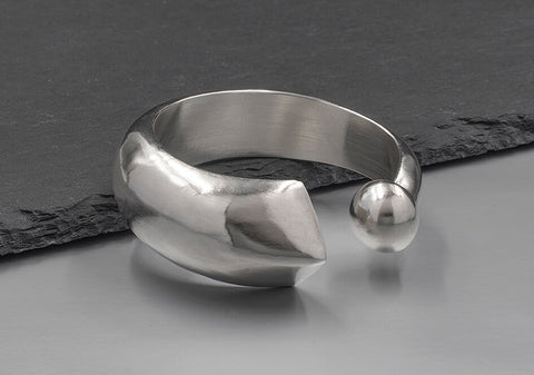 Close-up of the Apsara Bangle showing the sharp triangular tip and smooth rounded end on solid pure silver