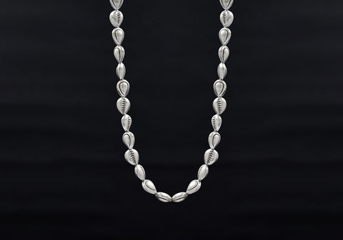 Close-up of pure silver shell beads and fish line stringing detail on the Harper Necklace