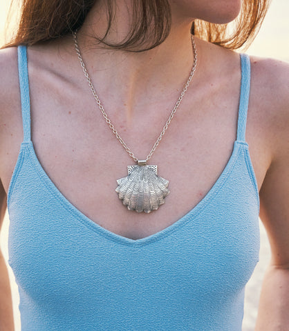 Amelia pure silver shell necklace worn at the beach, styled for a relaxed coastal summer look