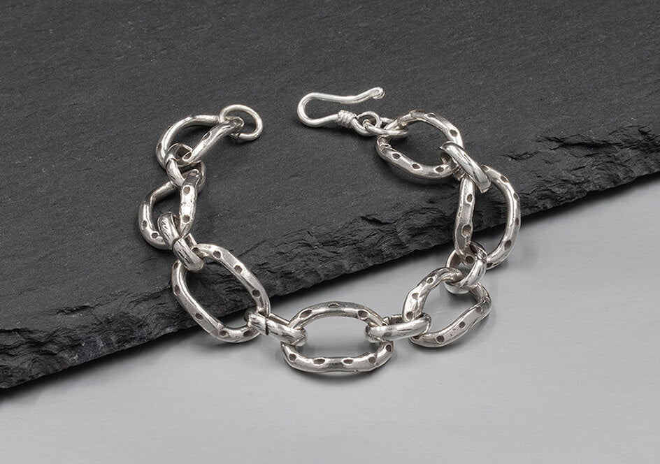 Close-up of the Delilah Chain Bracelet showing the fluid interlocking link detail and pure silver finish