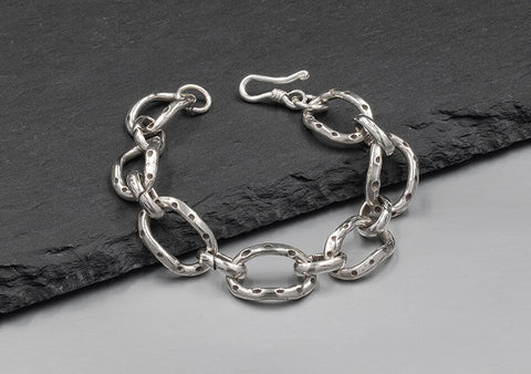 Close-up of the Delilah Chain Bracelet showing the fluid interlocking link detail and pure silver finish