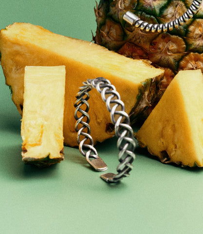 Side view of the Elowen Bangle highlighting its braided silver design and open cuff construction.