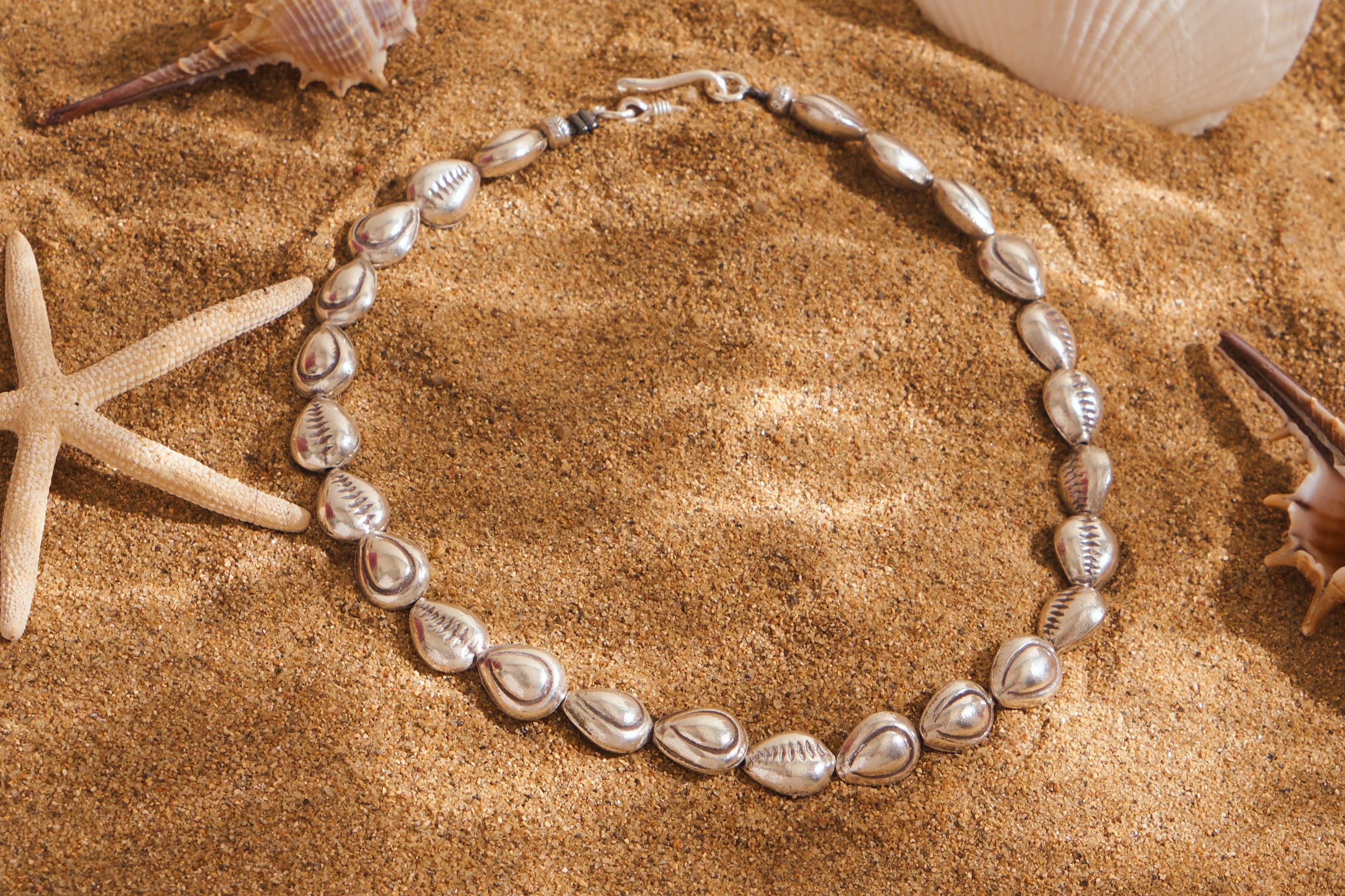 Delicate shell bead necklace in pure silver, perfect for summer layering and poolside wear