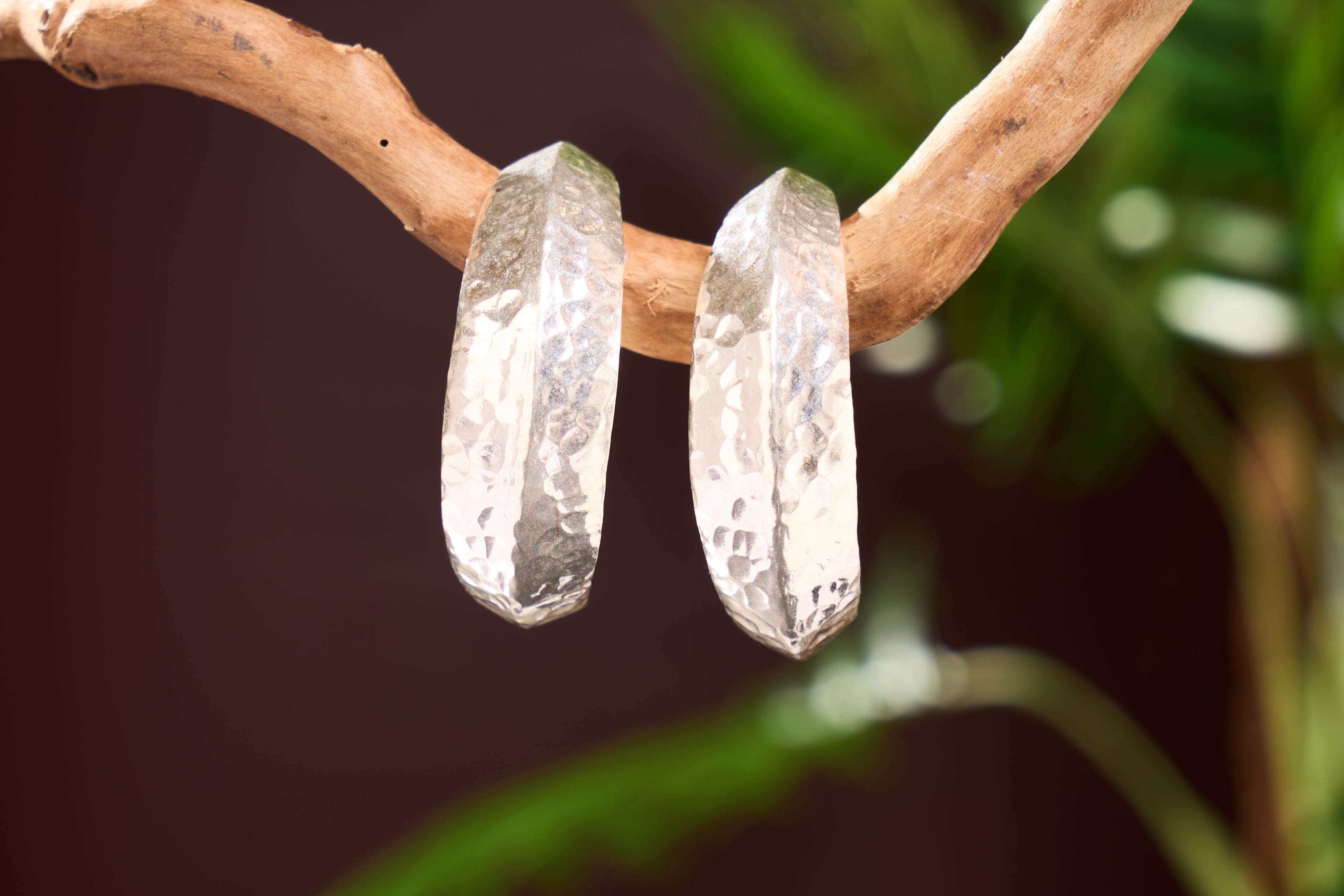 Close-up of hammered pure silver finish on Helena Hoop earrings, showing light-catching texture and handcrafted detail