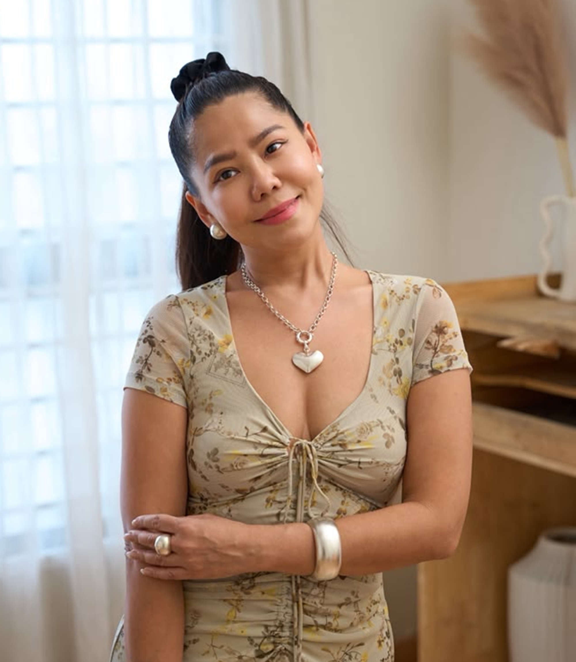 Ines Heart Necklace worn at the neckline, layered with fine silver chains for a modern everyday look