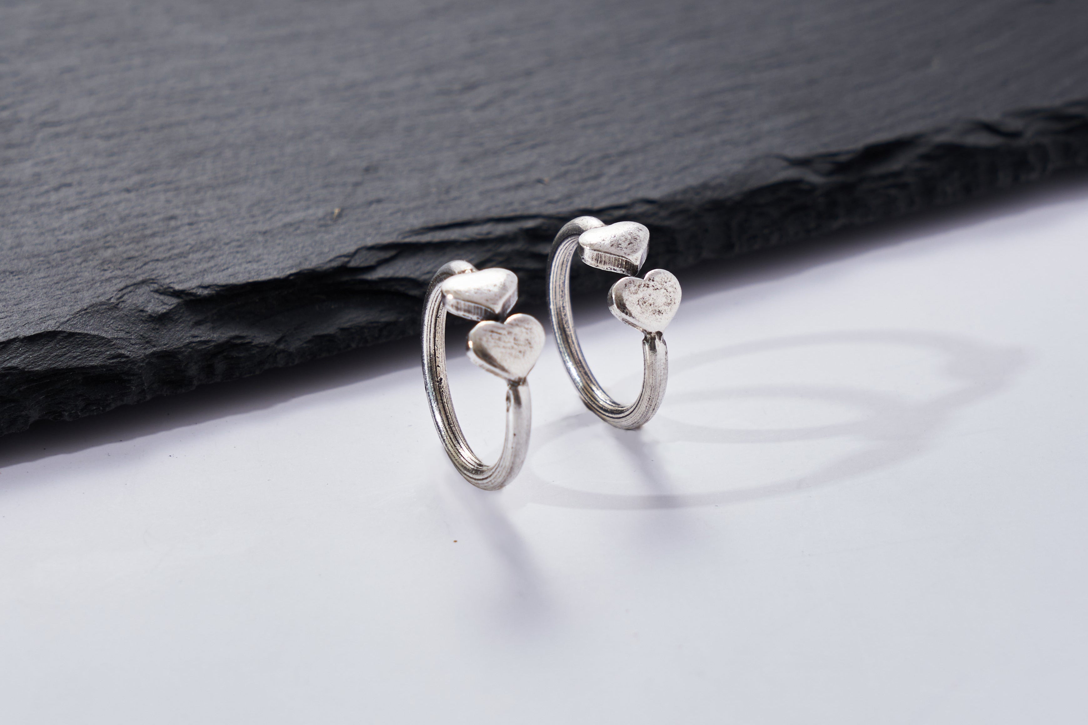 Close-up of the Jill Hear Ring showing delicate heart charm details and handcrafted finish in pure silver