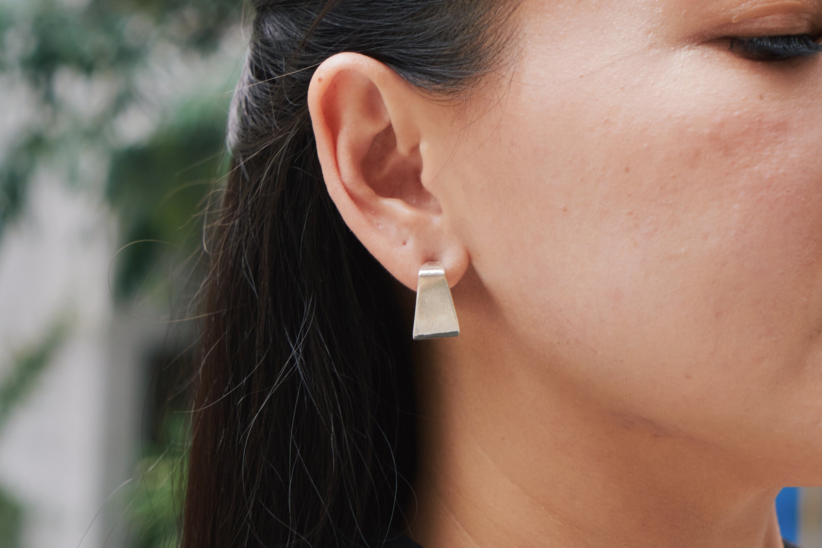 Jiva Studs worn on the ear, styled with a clean minimal outfit for an everyday modern look