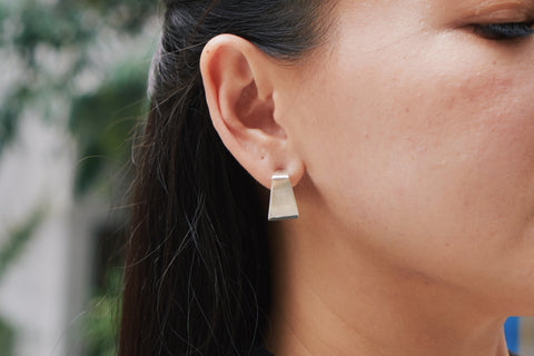 Jiva Studs worn on the ear, styled with a clean minimal outfit for an everyday modern look