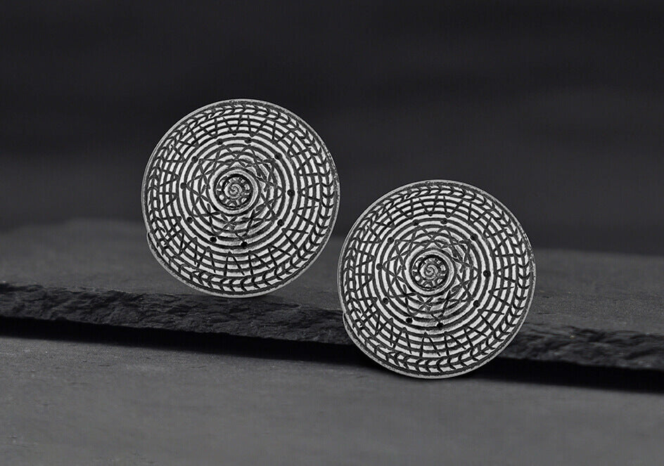Close-up of Lawana pure silver stud earrings showing smooth handcrafted surface and post detail