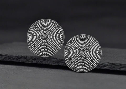 Close-up of Lawana pure silver stud earrings showing smooth handcrafted surface and post detail