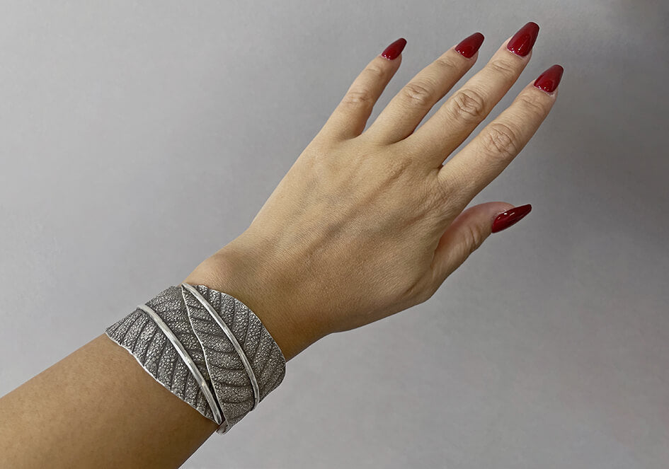 Model wearing the Leila Statement Cuff, a bold artisan pure silver bracelet for everyday styling.