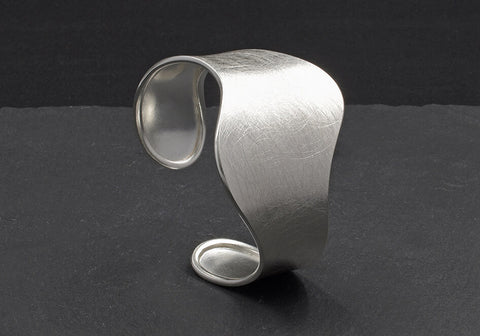 The Lydia Bangle, a minimalist pure silver bangle for everyday styling.