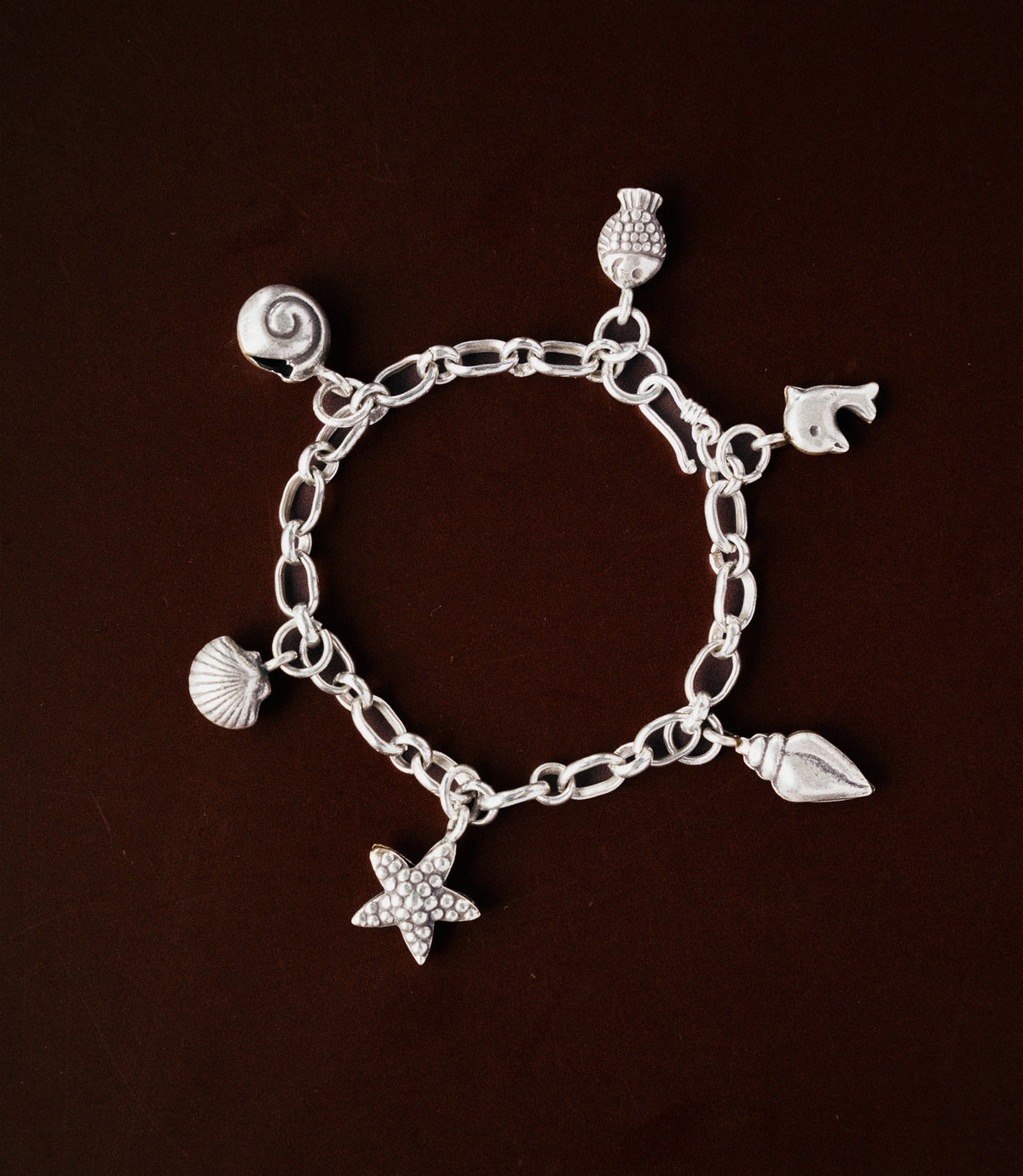 Model wearing the Maren Charm Bracelet, a pure silver charm bracelet with coastal-inspired details for everyday styling.