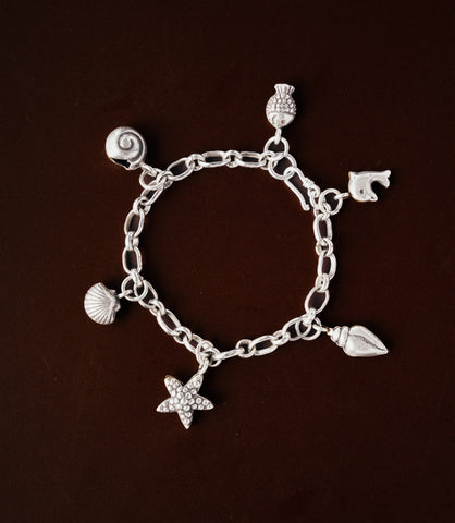Model wearing the Maren Charm Bracelet, a pure silver charm bracelet with coastal-inspired details for everyday styling.