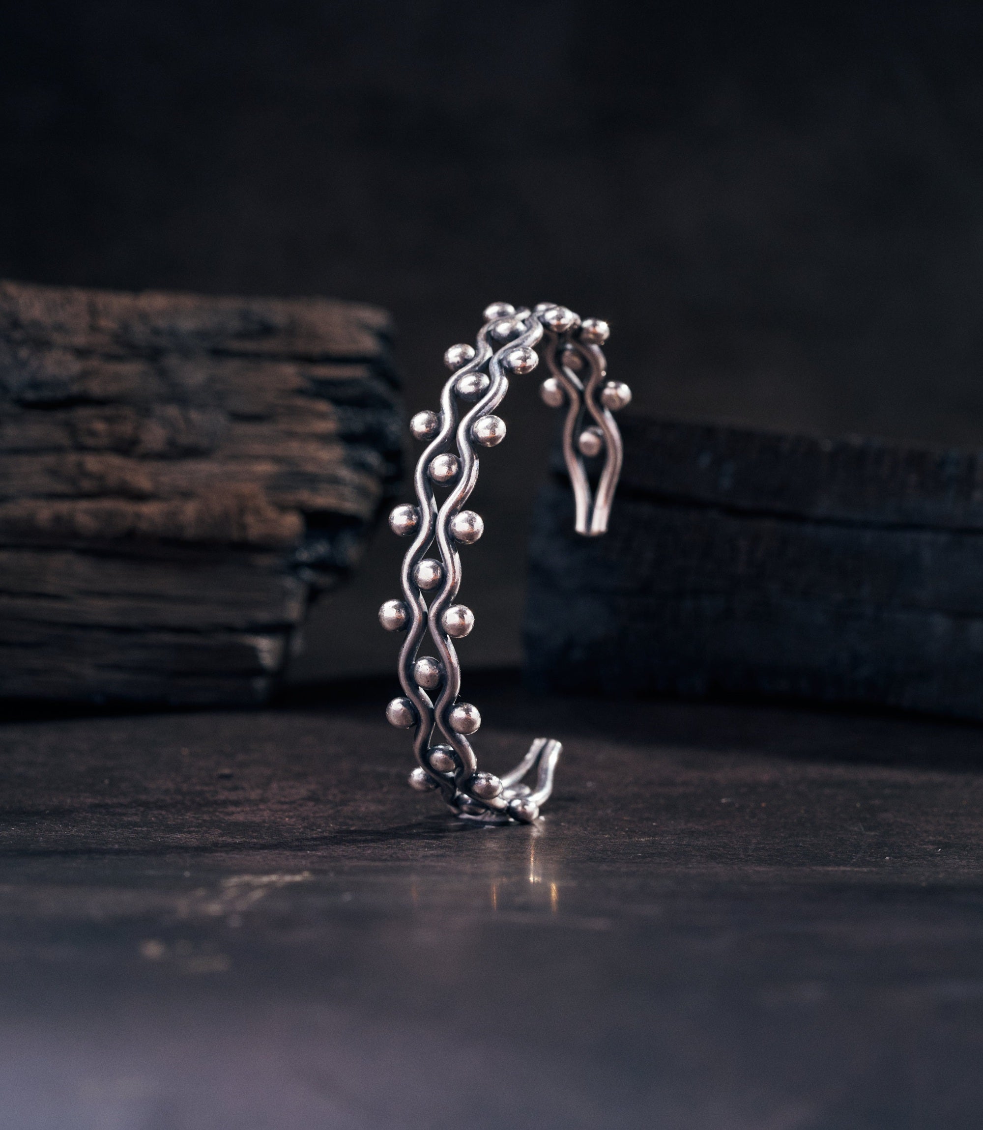Mariela Bangle in pure silver showing wide wave-form cuff with tribal motifs and dot-work detailing.