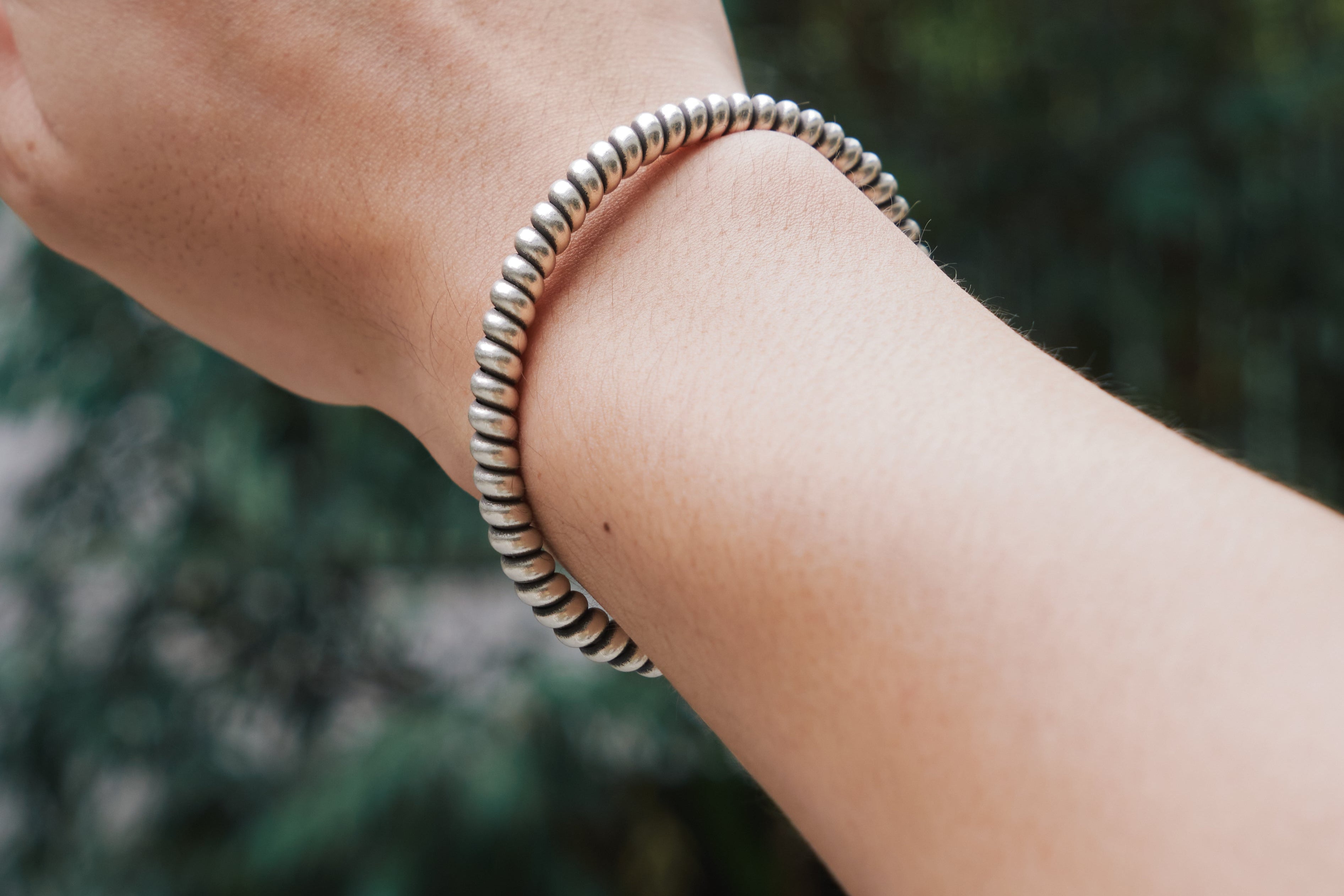 Naari pure silver bangle worn on wrist, stacked with other bangles for an everyday minimalist look