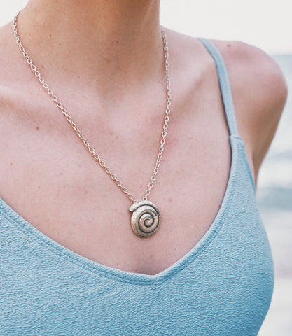 Model wearing the Nerida Necklace, a beach-inspired pure silver spiral pendant necklace for everyday styling.