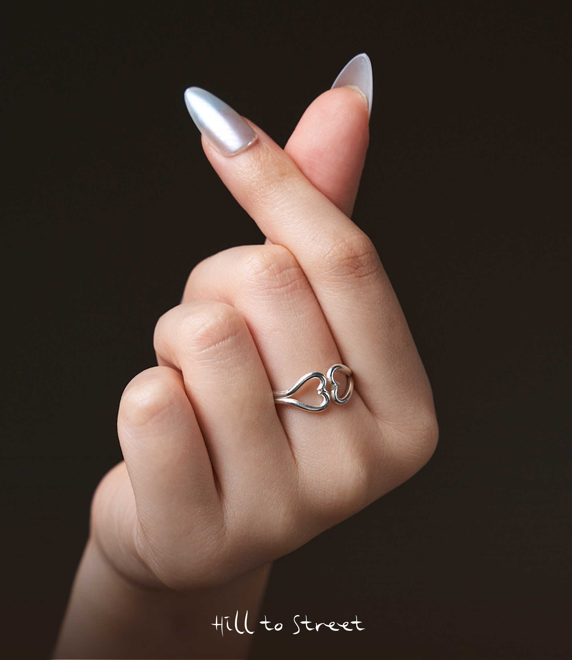 Model wearing the Open Heart Ring, a minimalist pure silver heart ring styled for everyday wear.