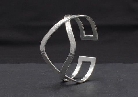 Close-up of hand-hammered pure silver surface on the Petra Cuff Bangle showing wave-inspired texture and light reflection