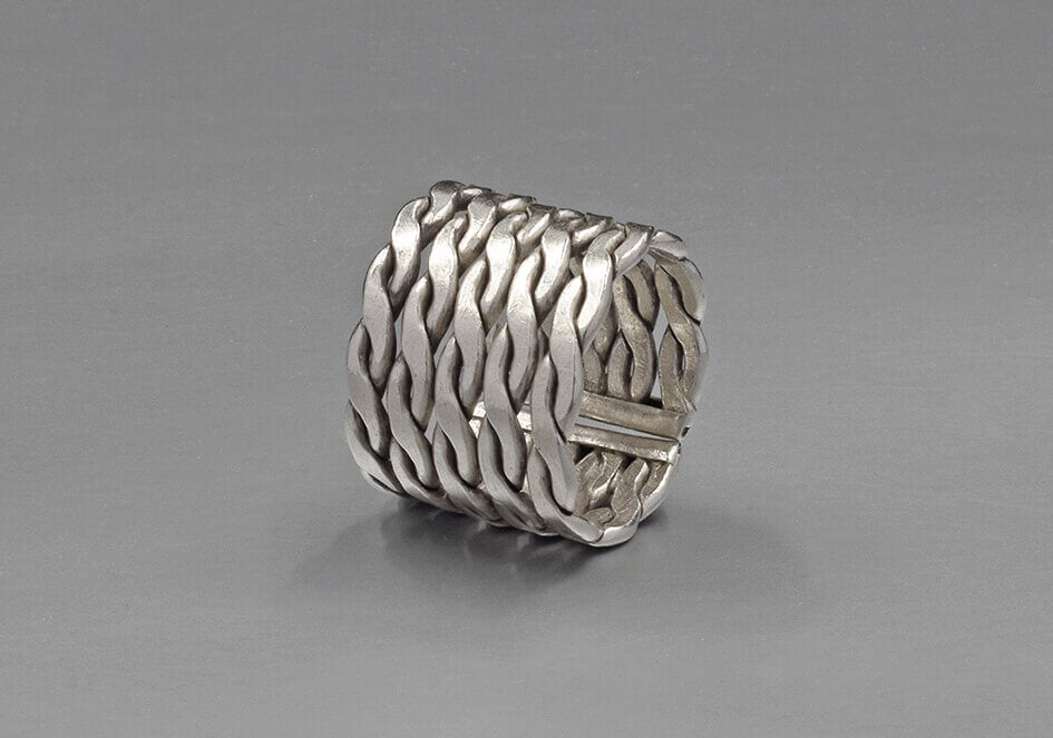 Close-up of twisted flat wire weave detail on sterling silver 925 Remy ring showing artisan silversmithing craftsmanship
